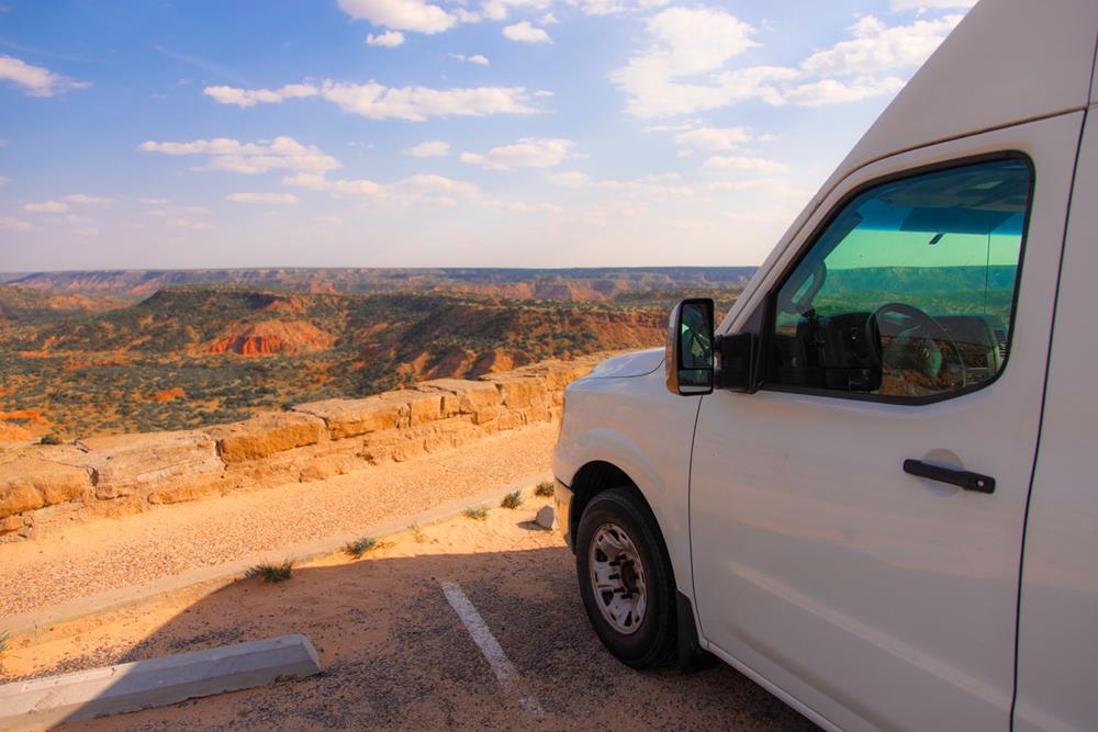 A vanlife camper parked to camp overnight with a beautiful view of Palo Duro Canyon in Texas